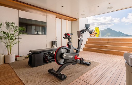 Overview of the beach club with gym equipment onboard charter yacht MOSKITO