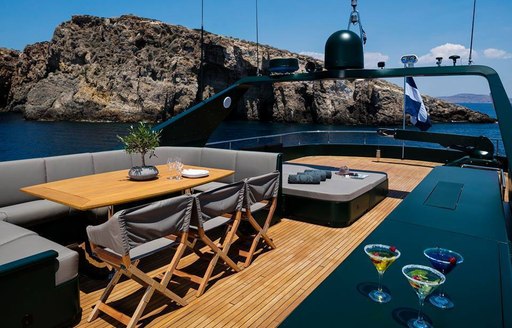 luxury yacht cant remember sundeck with backdrop of greek scenery