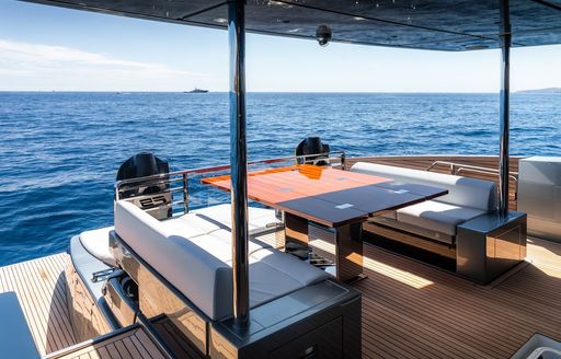 Charter yacht L'AS BLEU exterior seating area with table