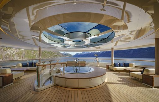 Aft deck seating area with glass skylight on board superyacht Flying Fox