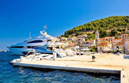 A motor yacht charter berthed in a quiet port in Croatia