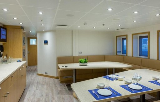 Interior of Game Changer yacht with laid out dining surface