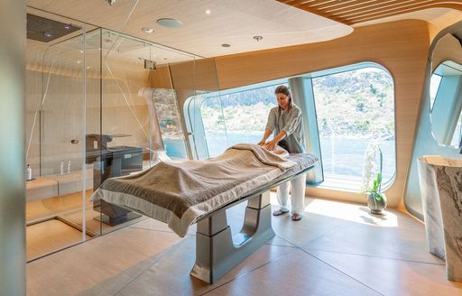 Charter yacht THIS IS IT interior massage table with charter guest receiving treatment