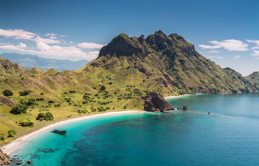 Island in Indonesia with white beach and green landscape