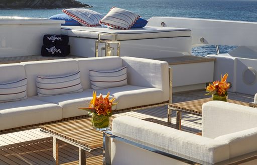  Comfortable cream seating areas outside on Victoria Del Mar, with wooden tables between them