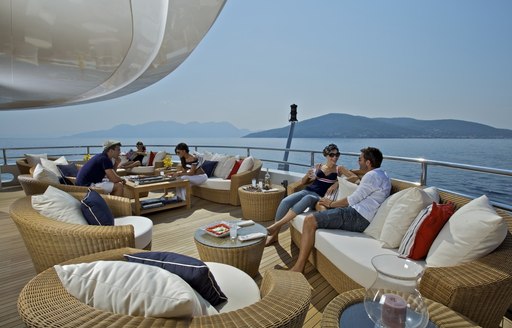 O'MEGA's charter guests relax on deck