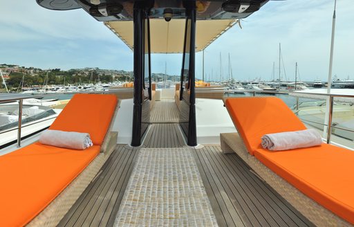 Orange sunpads on sundeck of luxury yacht CONQUISTADOR