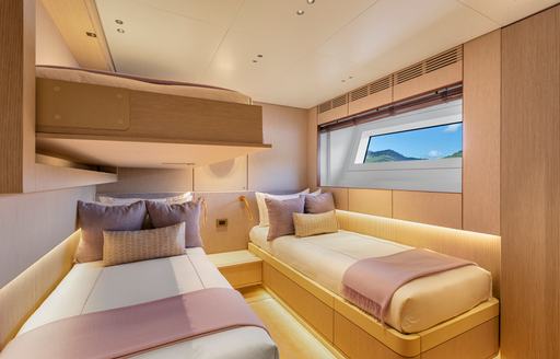Twin cabin with two single berths and a window onboard charter yacht LIV LOVE