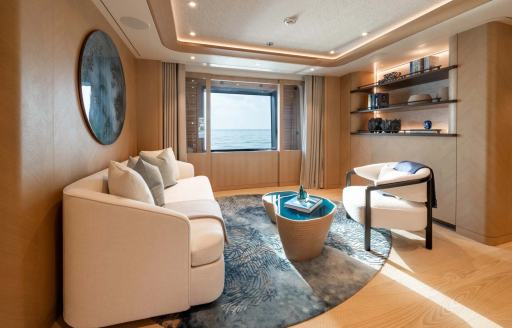 Superyacht charter QU2 private seating area in master cabin