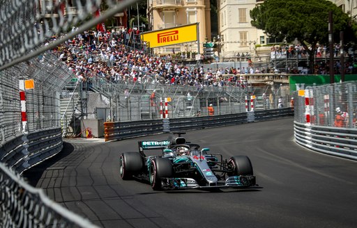 Spectators watch a Formula one car racing at the Monaco Grand Prix
