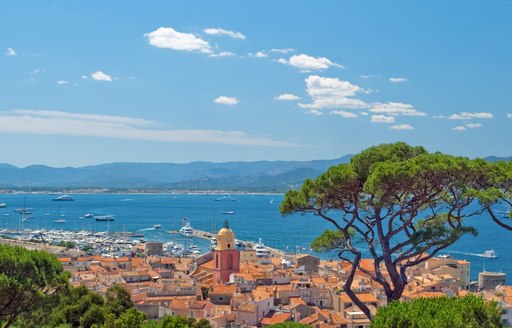 View of St Tropez and charter yachts anchored in the bay