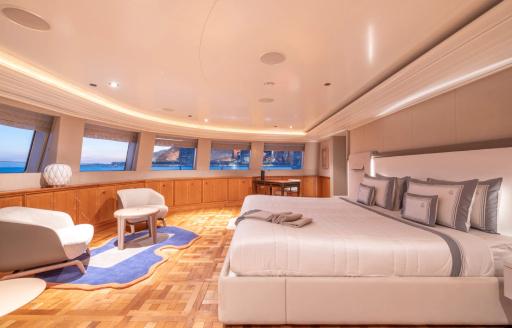 Master cabin with central berth and multiple windows onboard charter yacht CARINTHIA VII