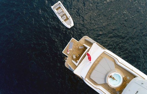 charter guest relaxes in the spa pool on the sundeck of luxury yacht Calypso