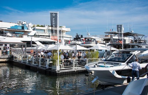 Overview of a Cannes Yachting Festival exhibitor with a motor yacht in the foreground