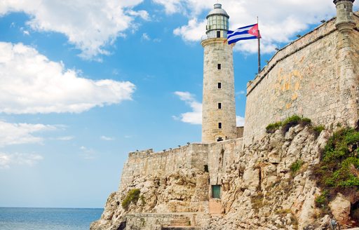 Overview of the Castle of the Three Kings of Morro with a Cuban flag