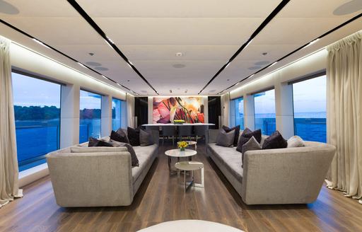 Charter yacht OURANOS interior lounge area with adjacent windows either side