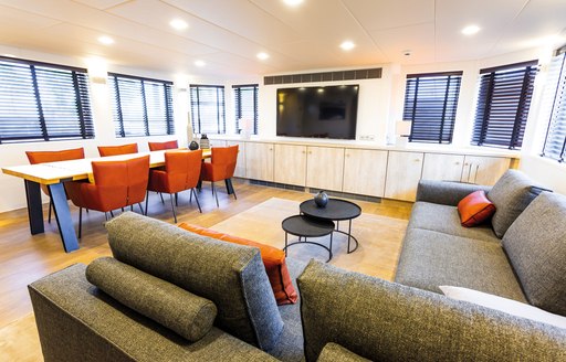 Dining area and sofa seating on board yacht JOY RIDER