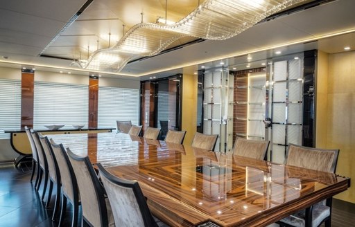 rosewood dining table under 7m chandelier aboard luxury yacht Party Girl