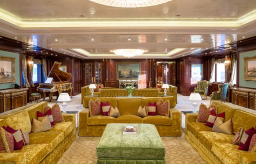 Main salon lounge seating with mustard sofas onboard charter yacht BLACK PEARL