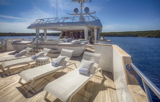 Sun loungers on deck of superyacht KATINA with blue Caribbean sea in background