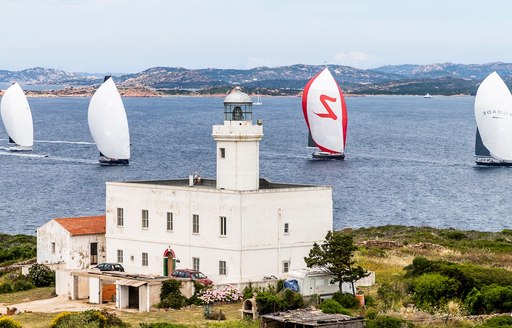 House in foreground with yachts racing in background in Porto Cervo