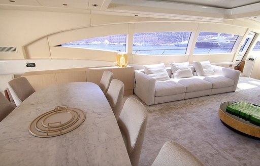 Table and sofa in interior charter yacht NEOPRENE