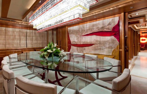 formal dining area with chandelier above in main salon of motor yacht EMOTION