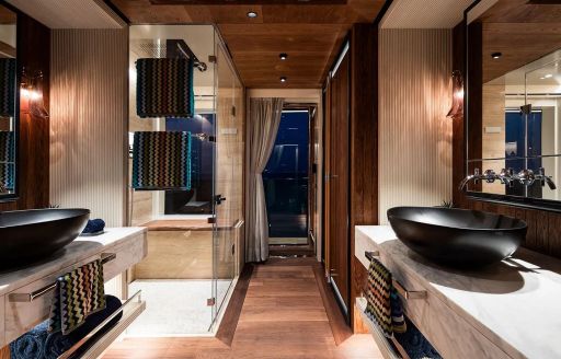 Ensuite facility with black sink ans separate shower cubicle onboard charter yacht KING BENJI