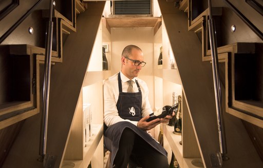 A man choose a wine onboard SY Satori