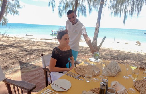 A guest enjoying alfresco dining on the beach at the Thanda island resort on the Indian Ocean