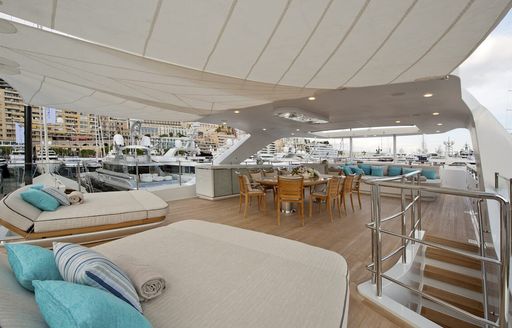 Sun deck with dual sun pads and alfresco dining onboard boat charter SCORPION