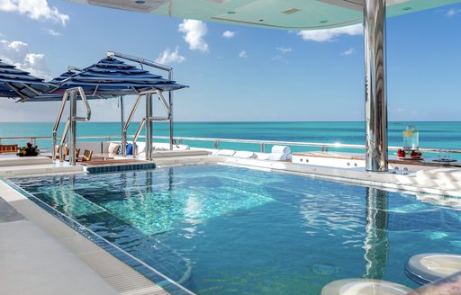 Swimming pool on the deck of superyacht charter TITANIA