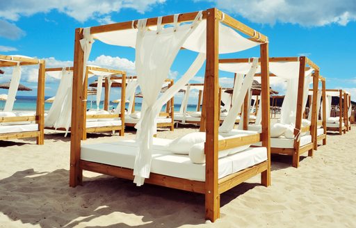 White sunbed in the sand on the island of Ibiza