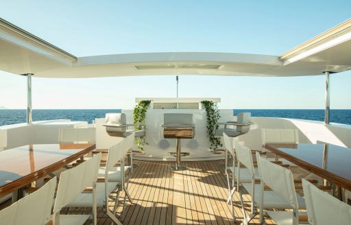Charter yacht VERTIGO sun deck with wet bars and stools