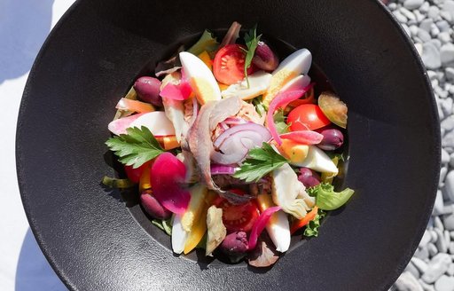 Refreshing salad in black bowl