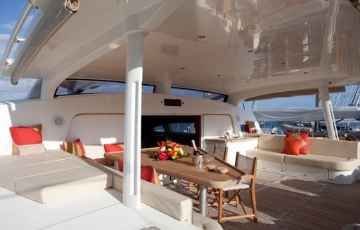 Table and comfortable seating area on deck of superyacht Orion