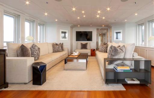 Main salon lounge with multiple windows onboard charter yacht BRAVADO