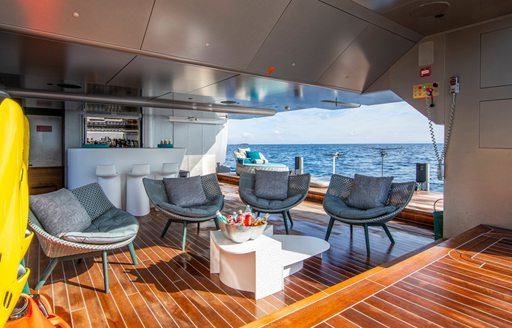 Overview of the beach club onboard charter yacht PANDION PEARL with armchairs facing the sea