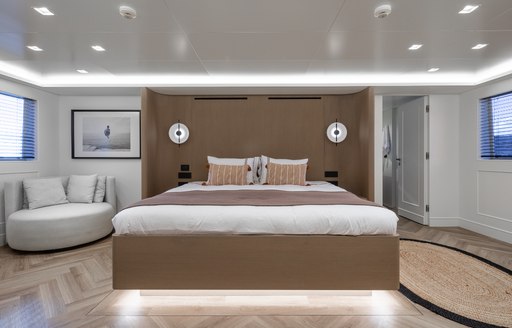 Master cabin onboard charter yacht ILLUSION II, central berth with seating to port