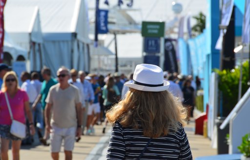 Woman walks down the boardwalk at FLIBS 2019