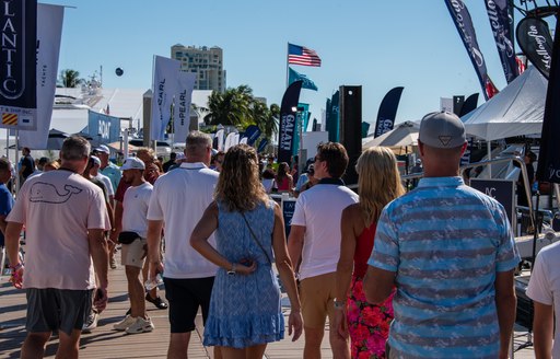 Group of visitors walking along the docks at FLIBS.