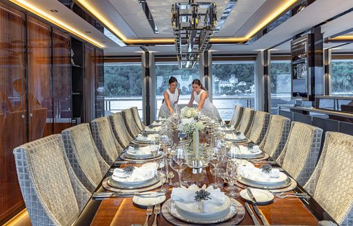Superyacht charter TOP FIVE II interior dining table set for a meal