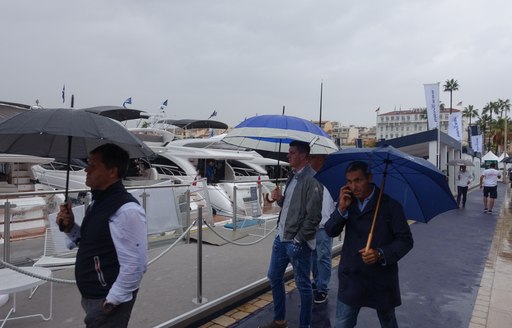 People at Cannes Yachting Festival 2020 covering below umbrellas