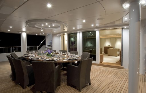 Dining table on aft decks of superyacht Triple 7