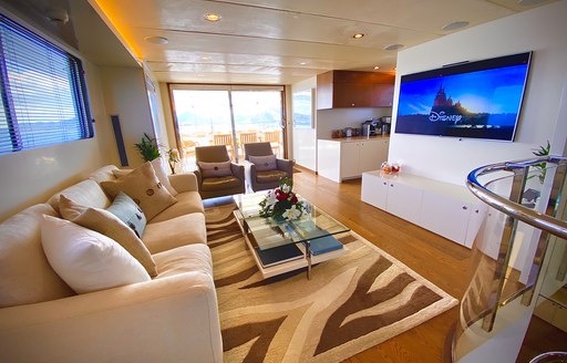 Sofa facing large flatscreen TV on superyacht LIONSHARE