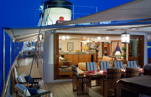 alfresco dining setup and lounge at night on board charter yacht TALITHA 
