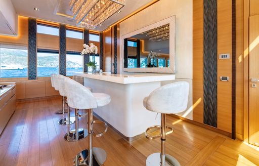 Charter yacht DB9 wet bar with white stools
