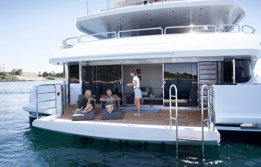 two guests on a luxury yacht charter enjoying their peace and quite while they are being served by their helpful and cautious crew during this COVID-19 outbreak 