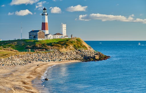 Candy-striped lighthouse on a cliff in USA