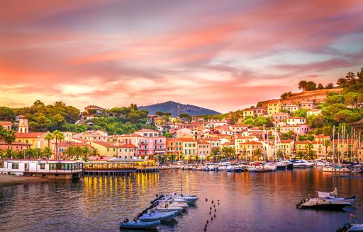 sunset over little island in italy